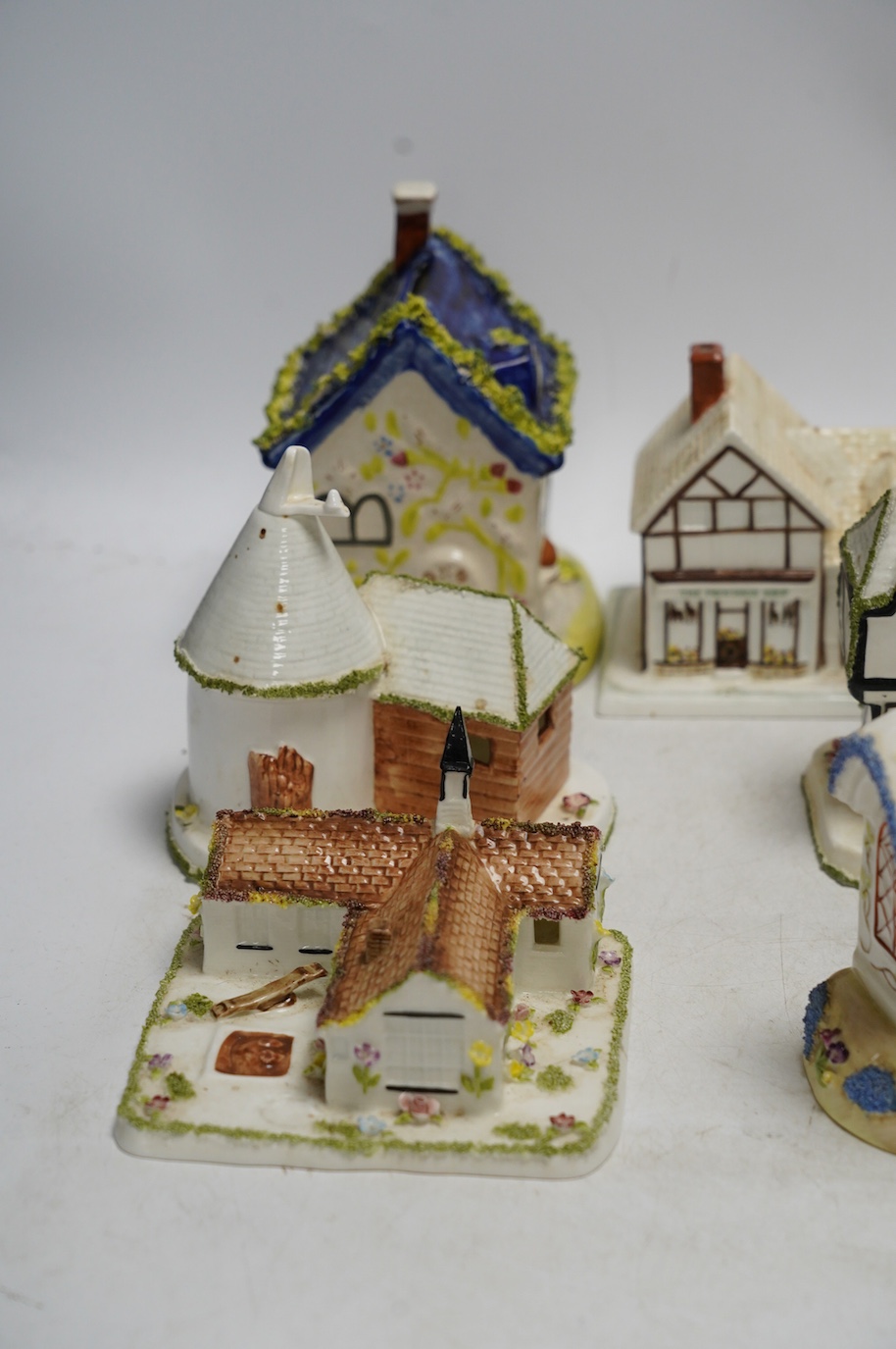 Ten various ceramic model cottages. Condition - fair to good